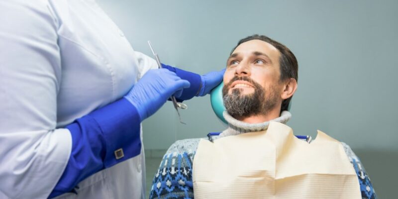 A dentist advising a patient on root canal aftercare for smooth recovery.