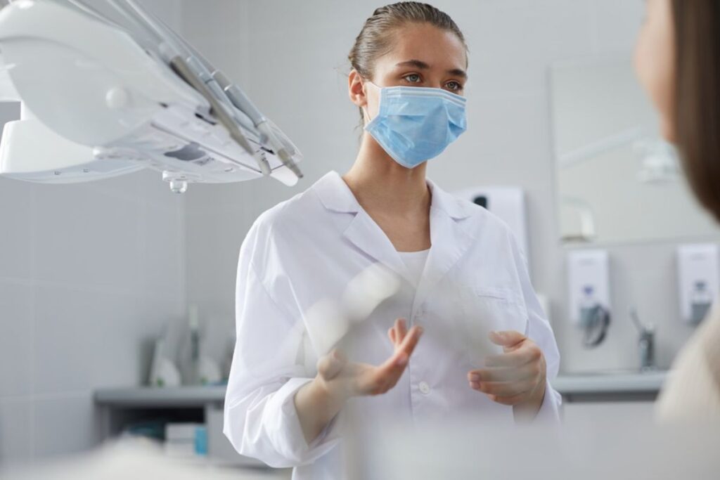 A dentist consulting a patient about bone grafting for dental implants.