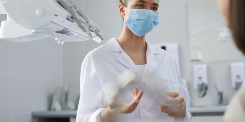 A dentist consulting a patient about bone grafting for dental implants.
