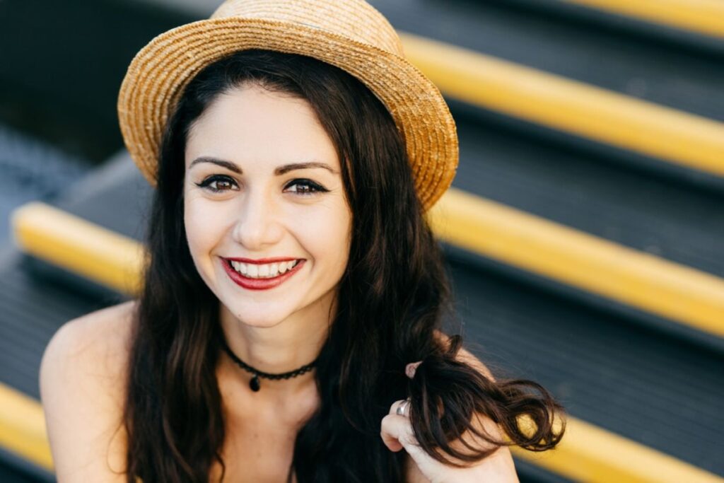 A happy patient with a bright, flawless smile after cosmetic dentistry treatment.