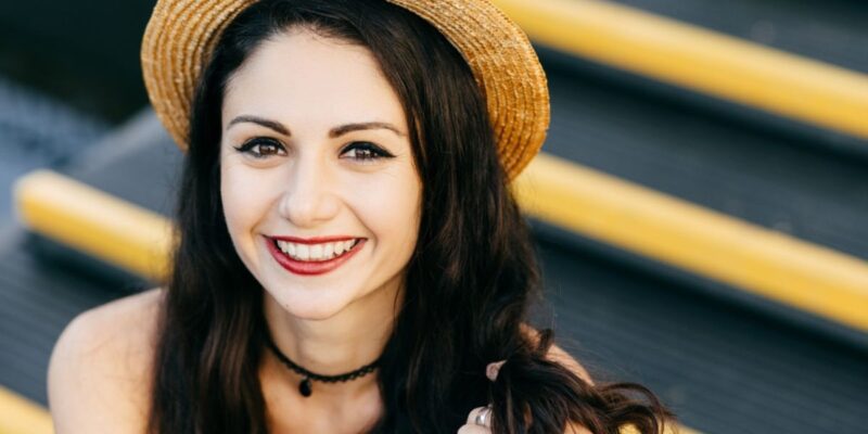 A happy patient with a bright, flawless smile after cosmetic dentistry treatment.