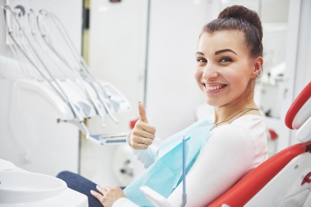 Happy patient showing smile after getting dental implants in Derry.