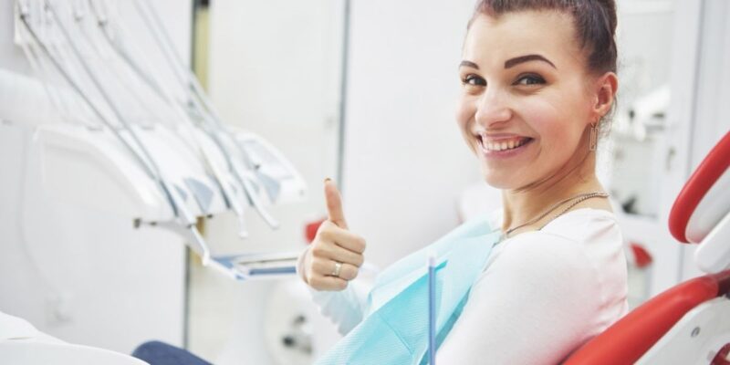 Happy patient showing smile after getting dental implants in Derry.