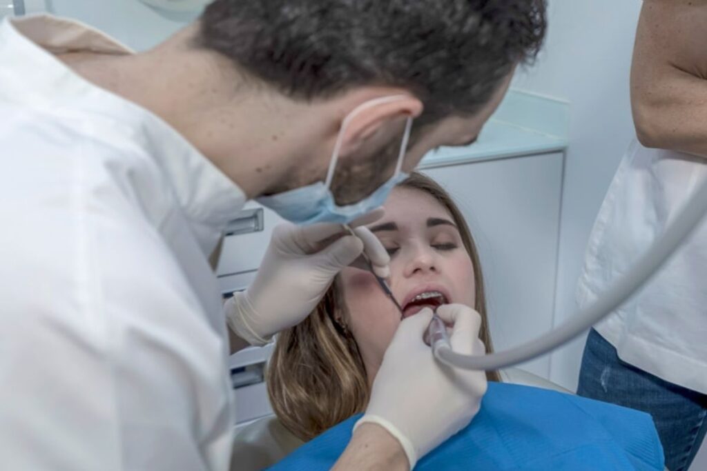 Patient receiving professional teeth cleaning at a dental clinic in Derry.