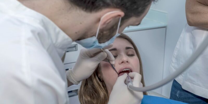 Patient receiving professional teeth cleaning at a dental clinic in Derry.